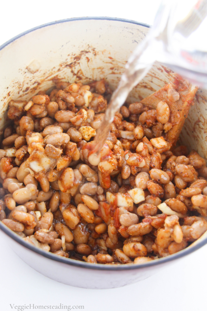 Mixing ingredients for a beans side dish. 